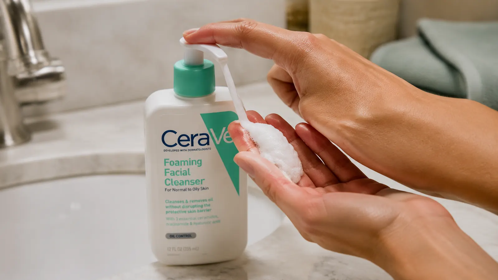 Hand pumping CeraVe Foaming Facial Cleanser into a lathered palm at the sink