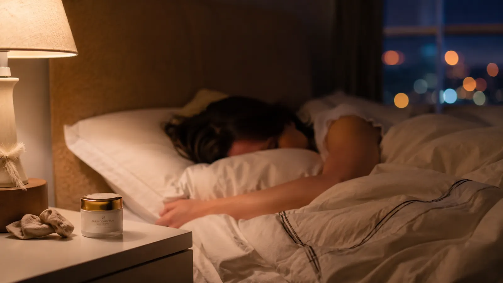 Person sleeping peacefully with a small lip balm jar visible on the nightstand beside them